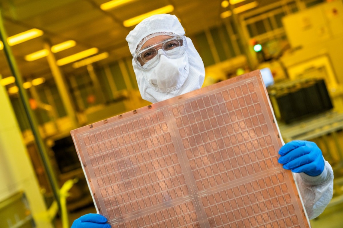 An Intel engineer holds a test glass core substrate panel at Intel's Assembly and Test Technology Development factories in Chandler, Arizona.