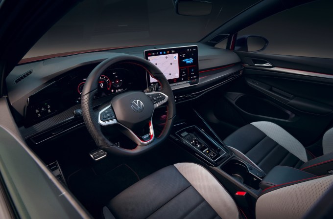 An image showing the interior of a new Volkswagen Gold including the steering wheel and touchscreen.